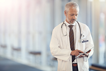 Image showing Typing, communication and a doctor with a tablet for healthcare, consulting and cardiology. Hospital, consultant and a mature surgeon with technology for a clinic schedule, agenda or planning