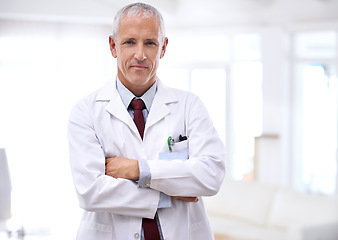 Image showing Senior man, doctor and portrait with arms crossed for health, wellness and helping in hospital. Mature healthcare expert, medic and professional with medical knowledge, experience and work in clinic