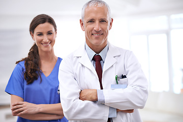 Image showing Doctors, man and woman in portrait with arms crossed for health, wellness and team in hospital. Mature healthcare expert, nurse and professional with medical knowledge, solidarity and smile in clinic