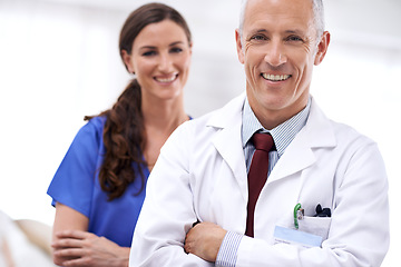 Image showing Doctors, man and woman with smile, arms crossed or portrait for wellness, health or hospital. Mature healthcare expert, nurse and professional with medical knowledge, solidarity or teamwork in clinic