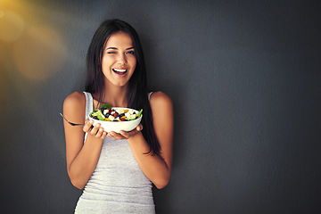 Image showing Woman wink with salad, healthy food and nutrition, portrait and vegetables isolated on wall background. Happy, body and health with wellness, diet and female model to lose weight with mockup space