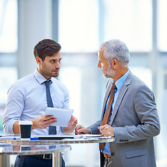 Image showing Discussion, tablet and business development team talking and in collaboration in a meeting for online information. Together, mentor and senior businessman coaching young person in training for job