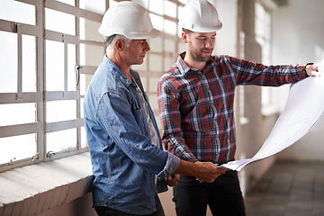 Image showing Architecture team, blueprint and engineer reading for planning, analysis or real estate development. Men, paper and design at property, construction site or building with helmet, discussion or vision