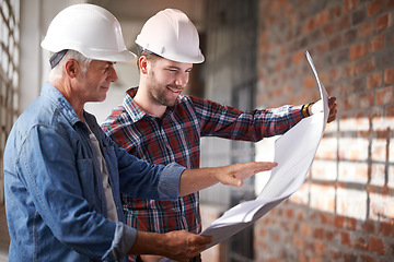 Image showing Architect team, blueprint and engineer reading for planning, analysis or real estate development. Men, paperwork and property design at construction site, building or helmet for consulting for vision