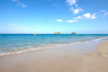 Image showing Water, beach and ocean landscape with clouds in the sky or travel to a tropical paradise, dream vacation or island holiday mockup space. Hawaii in summer, wallpaper and blue sea waves on sand