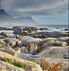 Image showing Sea, rocks and landscape with beach and waves, travel with summer vacation and outdoor. Environment, ocean view and seaside location with tropical destination and journey with nature and adventure