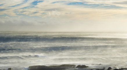 Image showing Water, sky and sunrise with waves or clouds in nature or outdoor for vacation, relax and travel. Horizon, sea and wind or wave and ocean landscape for a holiday or calm in the environment with light.