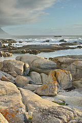 Image showing Ocean, rocks and landscape with beach and travel, waves and summer vacation outdoor. Environment, sea view and seaside location with tropical destination and journey on island, nature and adventure