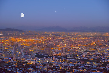 Image showing City, Cape Town and night view of building lights and architecture in the industrial urban town of South Africa. Late evening of outdoor scenery of moon or sky over buildings or cityscape structures