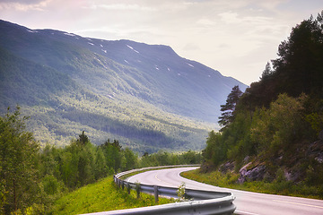 Image showing Road, mountain and travel with nature landscape, direction and destination with asphalt in Norway. Environment, street and location, journey and traveling view outdoor with horizon and countryside