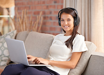 Image showing Headphones, laptop and portrait of a woman student on home sofa listening to music or streaming online. Happy female person smile, relax and learn new language with internet connection and tech