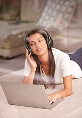 Image showing Laptop, headphones and a woman listening to music on a home sofa with internet for streaming online. Happy female person relax on couch with tech to listen to audio, radio or podcast for peace
