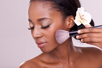 Image showing Cosmetic glow, makeup brush on face and black woman with skincare in studio, cosmetics tool. Skin care, blush and foundation, African beauty model with luxury contour highlight on pink background