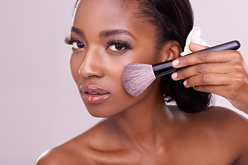 Image showing Portrait, makeup and black woman with brush in studio, cosmetic application tool and glamour. Skincare, blush and cosmetics, beauty model in luxury contour powder product on on cheek pink background.