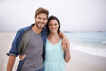 Image showing Portrait, couple and hug at beach for travel, romance and freedom while walking together outdoors. Love, face and happy woman embracing man on trip, vacation or holiday, bond or having fun in Florida