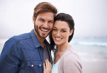 Image showing Portrait, hug and couple at a beach with love for travel, romance and freedom together outdoors. Face, smile and happy woman embracing man on trip, vacation or holiday, bond and having fun in Cancun