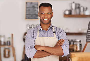 Image showing Black man, portrait smile and barista with arms crossed in cafe with pride for career or job. Waiter, happy and confidence of African person from Nigeria in restaurant, small business and coffee shop