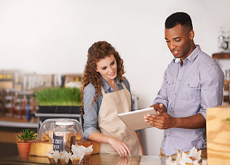 Image showing Tablet, coffee shop owner and teamwork of people, discussion and training. Waiters, black man and happy woman in restaurant with technology for inventory, stock check or managing sales in store.