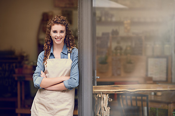 Image showing Retail, arms crossed and portrait of woman at restaurant, small business or waitress of coffee shop. Happy female entrepreneur smile at space of front door of cafe, diner and welcome to food industry