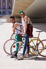 Image showing Bicycle, portrait and friends or men in city streetwear for college, university or outdoor travel in summer. Cool youth or people with gen z fashion, sunglasses and bike for urban transport at campus