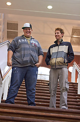 Image showing Students, teenager friends and boys walking down university and school steps with a smile. Conversation, talking and discussion of guy group feeling happy on education building stairs with a talk