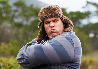 Image showing Angry, frustrated and young overweight man in nature during winter unhappy, grumpy and sad due to outdoor problem. Anger, obesity and person with stress arms crossed and fail walking in a forest