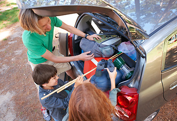 Image showing Happy family, road trip and packing car above for camping, holiday or vacation together in nature outdoors. Top view of dad and kids getting ready for travel, camp adventure or getaway in the forest