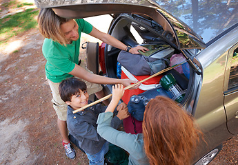 Image showing Happy family, car and packing for camping road trip, holiday or vacation above in nature outdoors. Top view of dad and kids getting ready for travel, camp adventure or getaway together in the forest