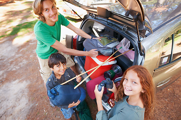 Image showing Happy family, portrait and packing car for road trip, holiday or camping vacation together in nature. Top view of father and children with smile for summer camp adventure, weekend or travel in forest