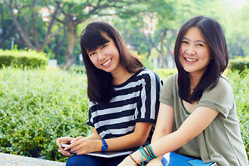 Image showing University, nature and portrait of girl friends with scholarship sitting outdoor on campus for education. Knowledge, smile and female college students in park for fresh air studying for test or exam.