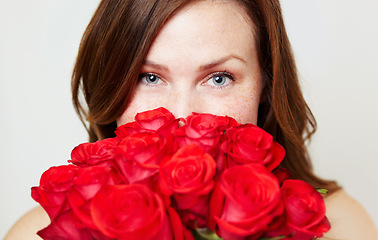 Image showing Roses, flower bouquet and portrait of woman with red gift for love, celebrate and a valentines day floral present or glamour. Aesthetic, skincare and eyes of female person or model with plants