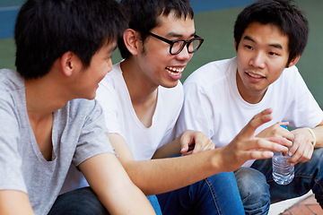 Image showing Smile, talking and a group of asian friends sitting outdoor on university campus as scholarship students. Funny, conversation or bonding with happy young men outside together during college break