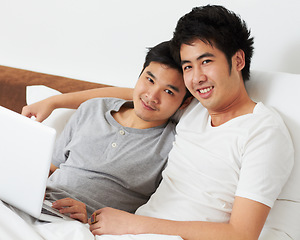 Image showing Portrait, laptop and bed with a gay couple watching a movie together while bonding in the morning. Love, happy or smile with an lgbt man and partner lying in their bedroom to relax while streaming