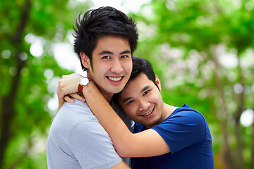 Image showing Asian men, gay couple and hug by trees, portrait and woods with love, care and bonding in summer sunshine. Happy Japanese man, romance and relax together in forrest with lgbtq, nature and holiday