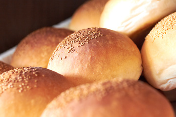 Image showing Sesame bread, food and bakery basket of rolls from cooking, catering service, breakfast or baking meal at cafe. Closeup of fresh baked, buns or roll snack for eating, nutrition or fiber in restaurant