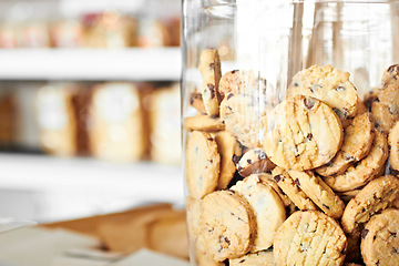 Image showing Dessert, bakery and closeup of jar with cookies for coffee shop, sugar and junk food. Cooking, chocolate and nutrition with oatmeal biscuit in container in cafe for snack, breakfast and pastry