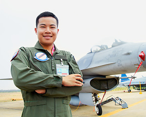 Image showing Portrait of asian man, fighter pilot with jet and confident smile at airforce base with arms crossed in Korea. Freedom, transport and proud Asian soldier with airplane, confident and service in army.