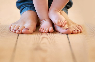 Image showing Closeup, feet and mother with baby in their home for walking, learning and love, bonding and routine. Toes, legs and parent with toddler on a floor for support, playing and fun, help and motor skills