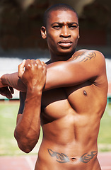 Image showing Body, stretching and man runner at a stadium for fitness, training and workout, warm up and focus. Start, stretch and African male athlete at a race track for cardio, exercise and sports performance