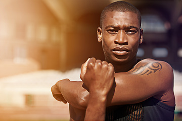 Image showing Fitness, portrait and man stretching arms outdoor for running, workout and training on blurred background. Face, stretch and African male runner with serious, focus and mindset, training and warm up