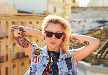 Image showing Tattoo, portrait and fashion woman with sunglasses in city, urban body art and stylish outdoor. Face, rooftop and edgy female person from Canada in cool denim clothes, jacket or serious punk attitude