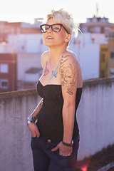 Image showing Cool, stylish and portrait of a woman with tattoos, unique style and creativity in the city. Trendy, creative and a lady with fashionable, punk and urban clothes on a rooftop for fashion and summer