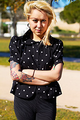 Image showing Tattoo, portrait and woman at park with arms crossed for stylish body art outdoor. Punk, confident or edgy young female person from Canada standing in cool clothes, trendy fashion or serious attitude