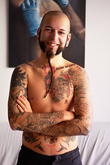 Image showing Happy, arms crossed and portrait of a man with tattoos, pride and happiness in a house. Smile, confidence and a person with body ink, creativity and punk identity in a living room in the morning