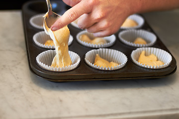 Image showing Closeup, tray and hand for cupcake dough with baker, small business owner and professional chef. Cooking, bakery and cake in baking pan for food, job or start process for muffin in restaurant kitchen