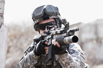 Image showing War, training and man with gun in the army for a target, service or a mission. Military, hero and a soldier with a rifle on the battlefield for shooting, danger or violence with a firearm for defense