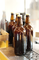 Image showing Assembly line, beer and bottles in factory, brewery or manufacturing plant. Alcohol glass, conveyor machine and automation of production in warehouse for industrial process in alcoholic industry.