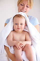 Image showing Baby, mom and hug for bath with care in a closeup for clean kid at home with love and caring. Towel, mother and infant with portrait to hold or hugs for care and love with kid in family home.