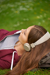 Image showing Woman, student and headphones for music on lawn to relax, summer and audio streaming subscription. Girl, campus grass and park with meditation sound, sleep and peace for listening, radio and podcast