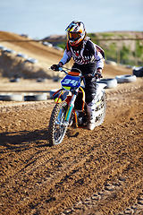 Image showing Adventure, offroad and biker riding a motorcycle with speed for a race or sport competition. Sports, fitness and male athlete on motorbike for adrenaline, training or practicing on outdoor dirt trail